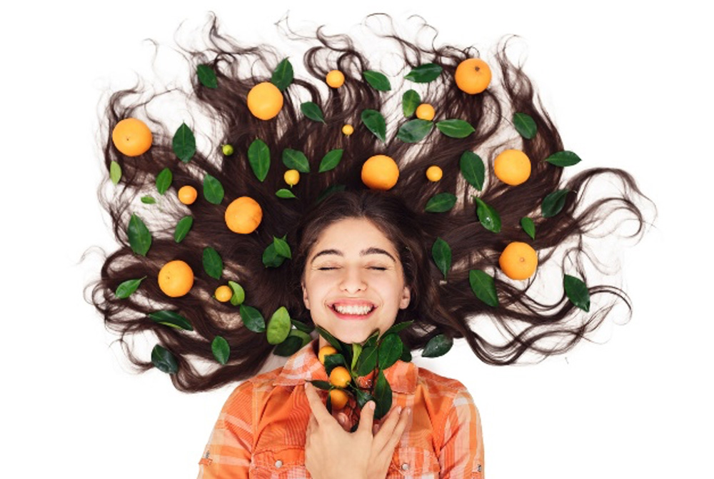 Woman with fruit in her hair.